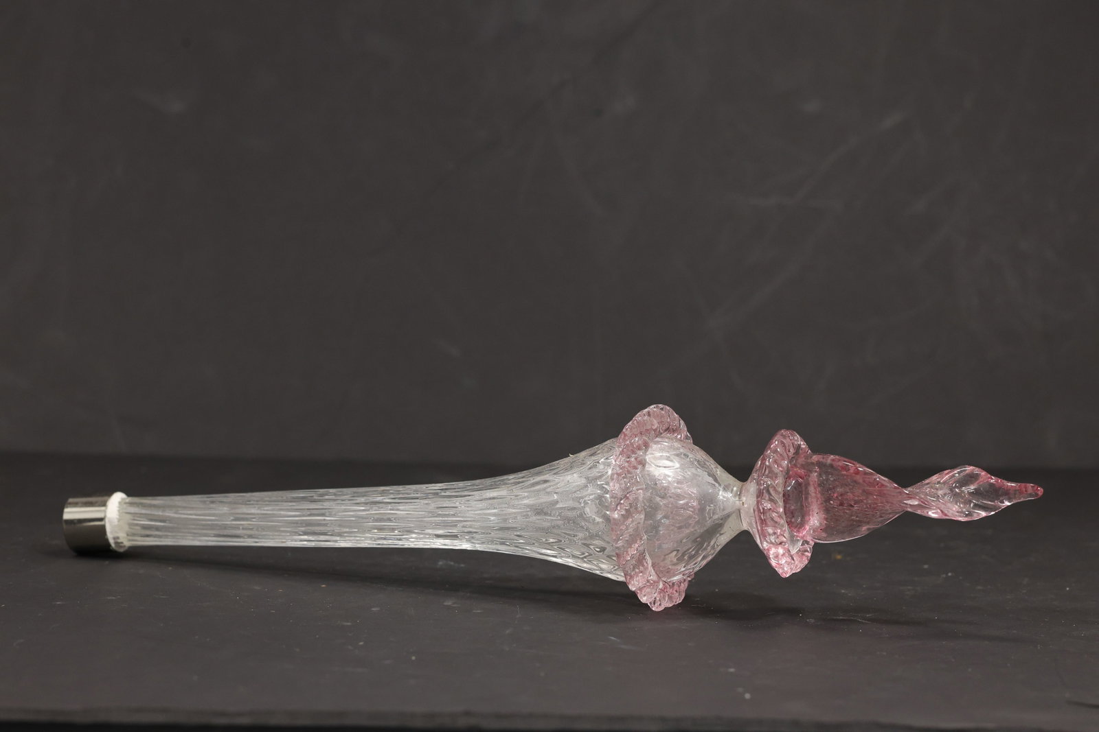 Pink and Clear Murano Glass Chandelier Stem Finial: Single vintage mid century Murano glass pink and clear decorative chandelier stem or finial from confirmed importer stock. The elongated component has a clear tapered body central pink floral knop and