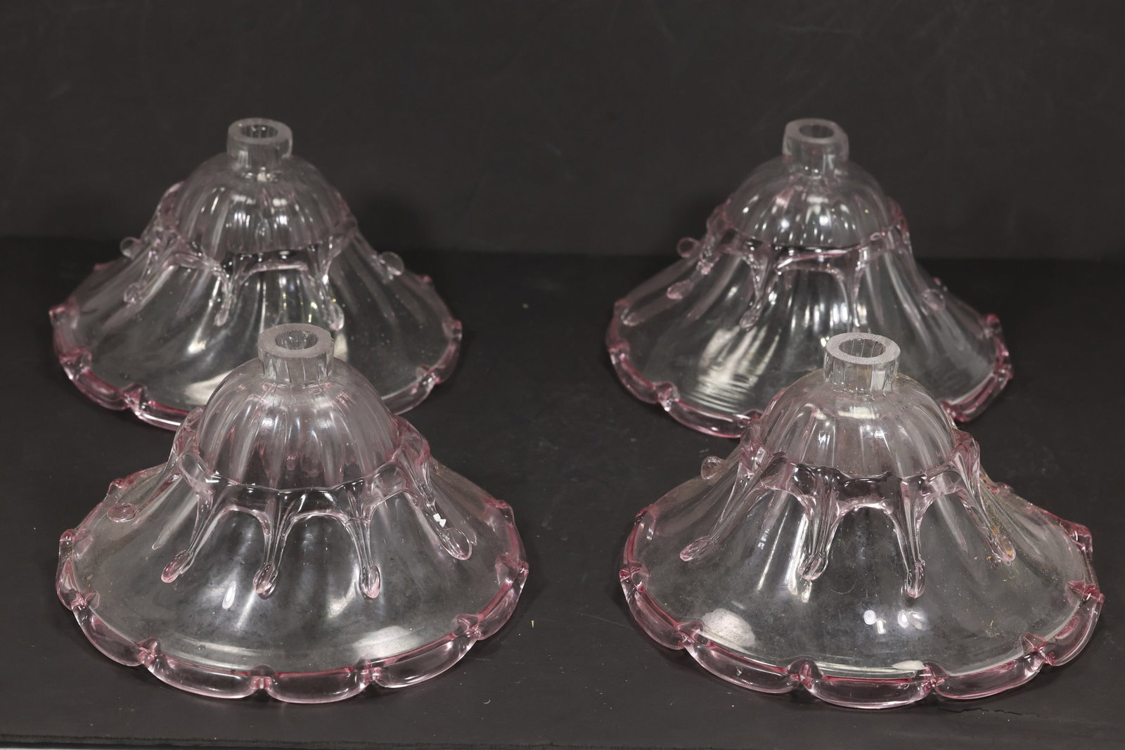 Set of Four Large Pink Murano Glass Bell Chandelier Shades: Set of four vintage mid century Murano glass large pink bell chandelier shades from confirmed importer stock. Each flared shade has vertical ribbing a petal shaped lower rim and a clear to rose color 