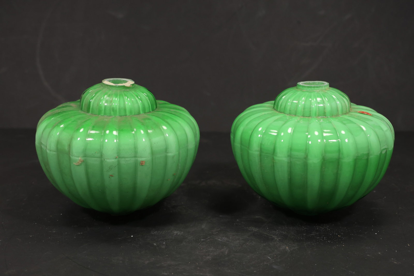 Pair Green Murano Glass Ribbed Chandelier Shades: Pair of vintage mid century Murano glass green ribbed chandelier shades from confirmed importer stock. Each rounded component has a pumpkin form body deep vertical fluting and a central mounting apert