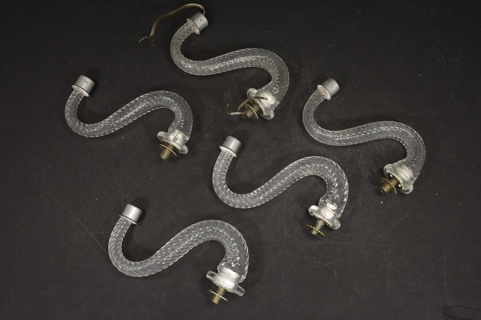Set of Five Clear Murano Glass Curved Chandelier Arms: Set of Five vintage mid century Murano glass curved chandelier arms from confirmed importer stock. Photographs show S shaped glass bodies with metal fittings at the ends in clear tones. Suitable as pe