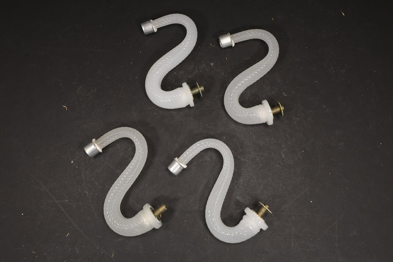 Set of Four White Murano Glass Curved Chandelier Arms: Set of Four vintage mid century Murano glass curved chandelier arms from confirmed importer stock. Photographs show S shaped glass bodies with metal fittings at the ends in white tones. Suitable as pe