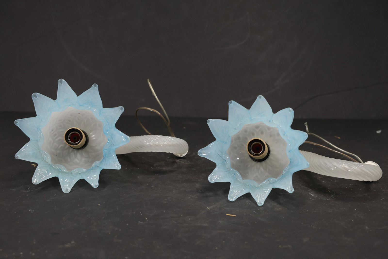 Pair Blue Murano Glass Flower Chandelier Stems: Pair of vintage mid century Murano glass flower chandelier stems from confirmed importer stock. Photographs show curved or straight supports ending in layered blossoms with modeled petals in blue tone