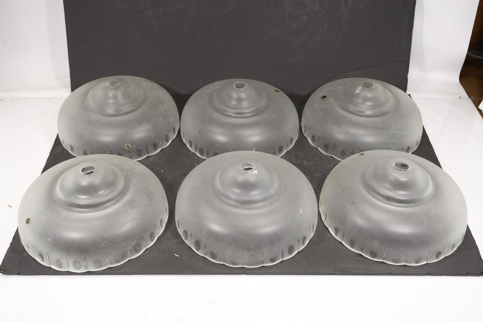 Set of Six Clouded Clear Murano Glass Chandelier Shades: Set of Six vintage mid century Murano glass chandelier shades from confirmed importer stock. Photographs show flared or domed bodies with central apertures and decorative rims in clouded clear tones. 