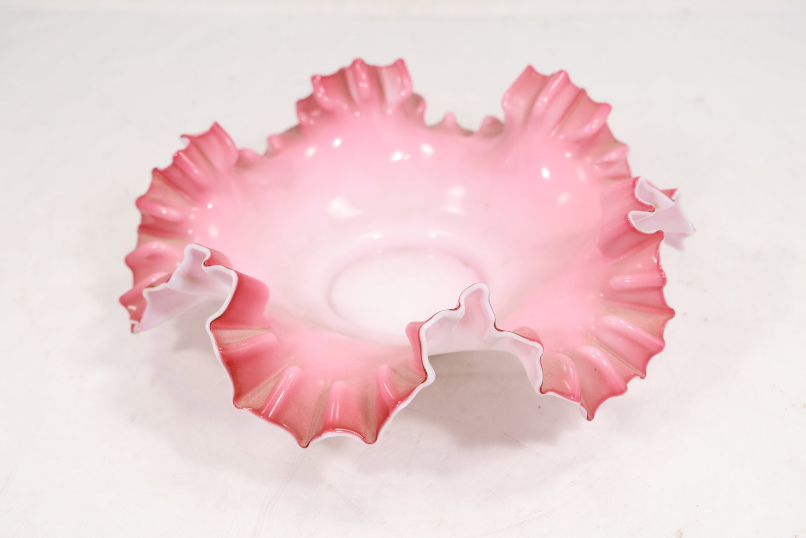 Victorian-Style Pink Cased Milk Glass Ruffled Bride's Basket Bowl: Decorative ruffled-edge art glass bowl featuring an elegant pink-to-white cased coloration. The piece displays a crimped and folded rim with pronounced ruffles, creating a floral, petal-like silhouett