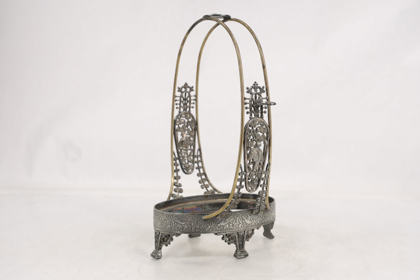 Victorian Silverplate Bridal Basket Frame with Bird Motif, Glass Insert Missing: Ornate Victorian silverplate bridal basket frame featuring pierced bird and floral decoration, engraved floral borders, and an elegant oval swing-form handle. Raised on four decorative feet with openw