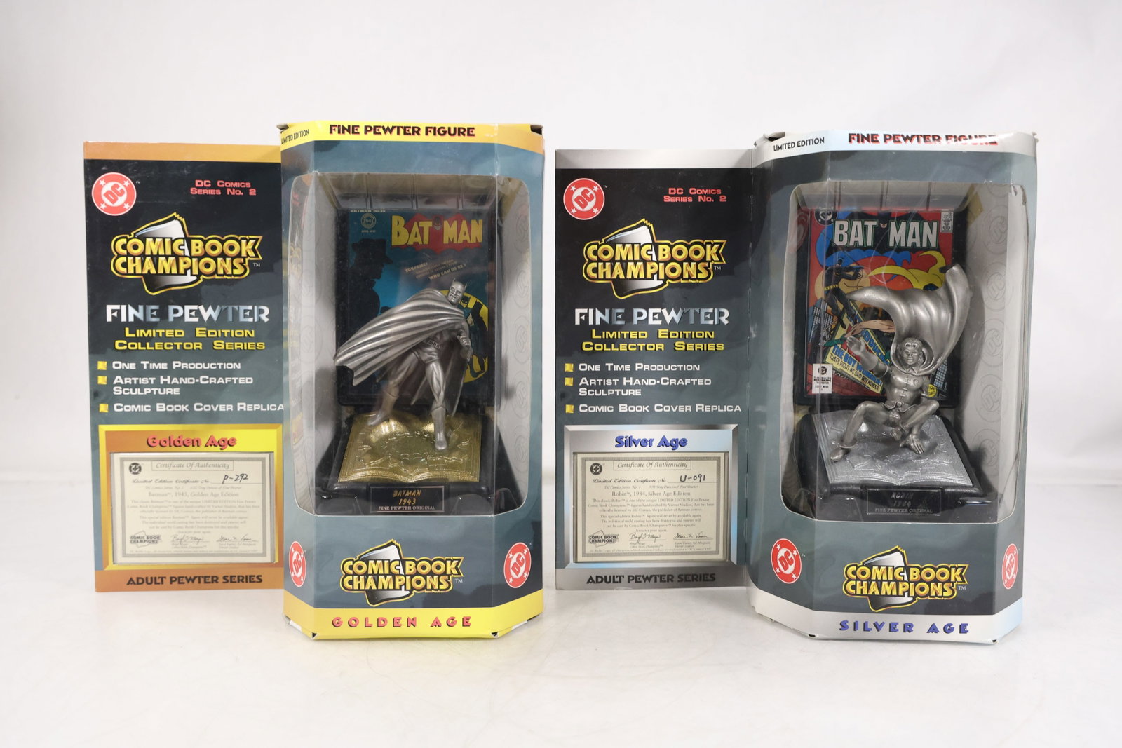 Comic Book Champions Batman Fine Pewter Figures – Golden & Silver Age New in Boxes: Pair of Comic Book Champions Batman fine pewter figurines, each housed in original display packaging and representing Golden Age and Silver Age comic book eras. Produced as collectible display pieces,