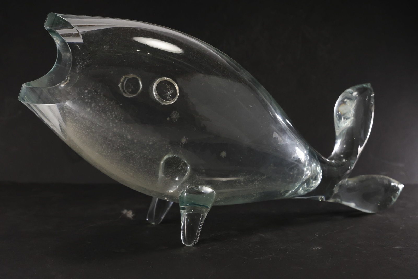 Blenko Glass Company Model #971 Clear Glass Fish Vase: Mid-century modern clear glass fish vase by Blenko Glass Company, model #971. Freeform sculptural design with a rounded body, applied fins and tail, and open mouth rim. Two applied circular eyes add c