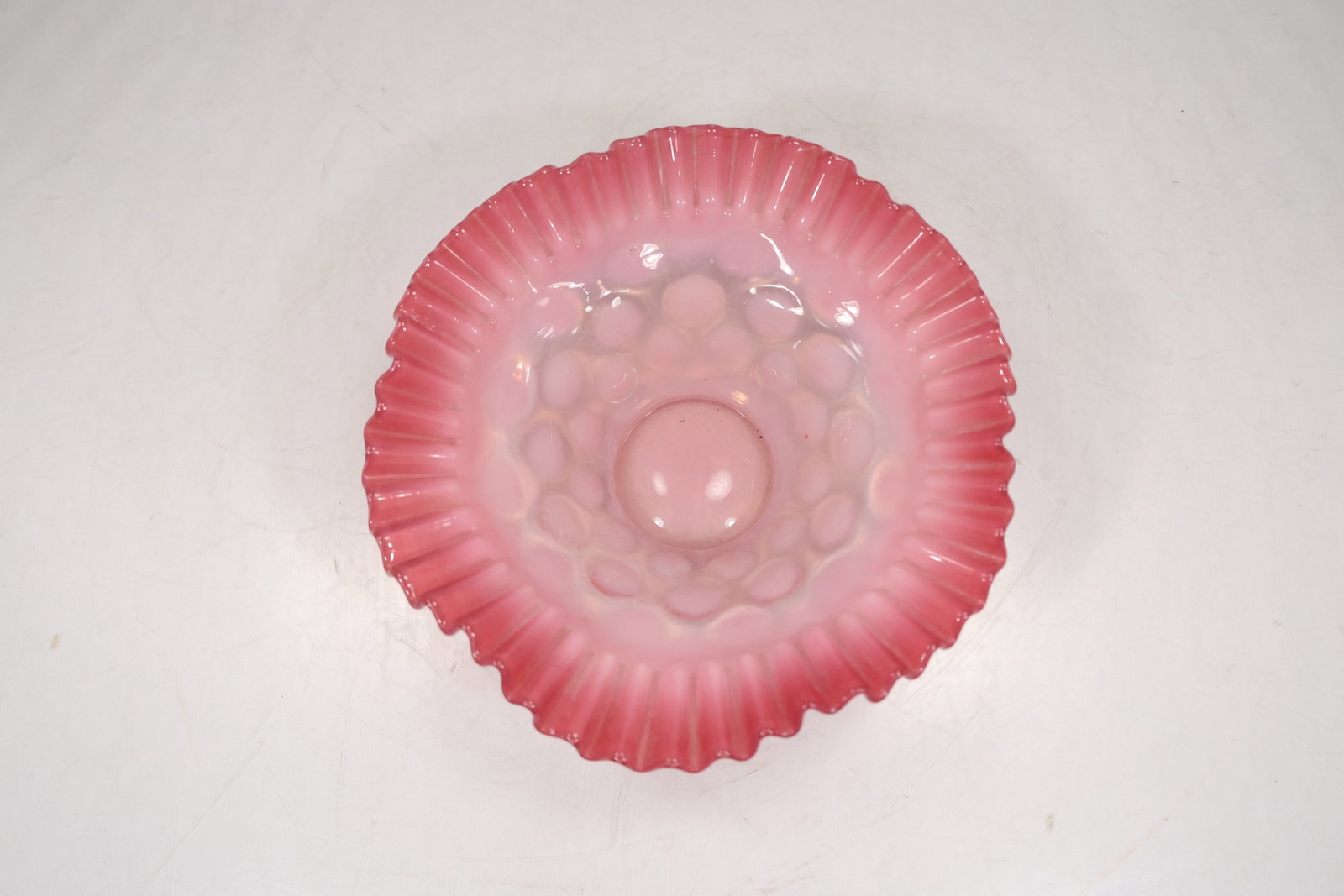 Fenton Cranberry Opalescent Hobnail Ruffled Bowl: Classic Fenton glass bowl in cranberry opalescent with the iconic hobnail pattern and ruffled edge. The color transitions from a rich cranberry rim to a softer opalescent center, giving it that glowin