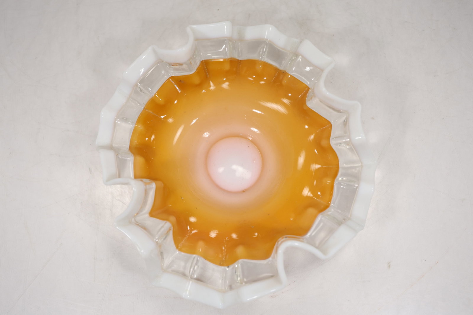 Antique Orange Glass Bride’s Basket Bowl with White Ruffled Rim: Antique bride’s basket bowl in vibrant orange glass, featuring a striking white opalescent ruffled rim. The color transitions from a rich amber-orange center to a soft, milky white edge, creating a 
