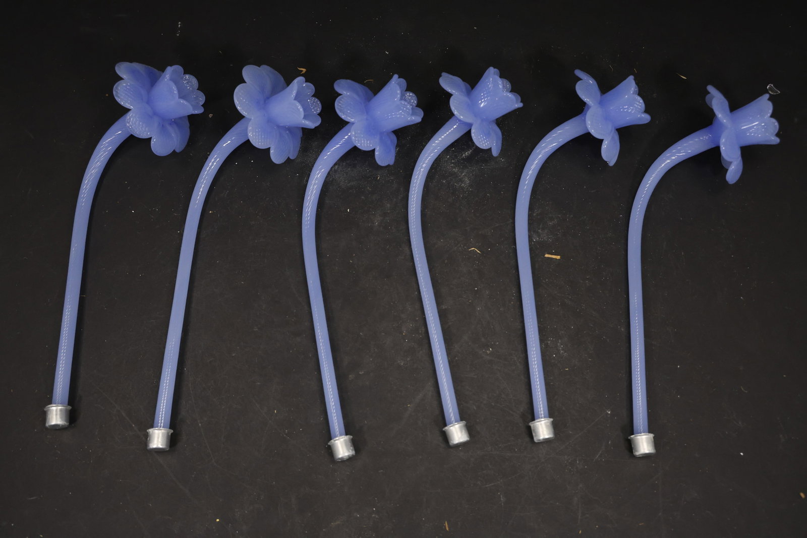Set of Six Blue Murano Glass Flower Chandelier Stems: Set of Six vintage mid century Murano glass flower chandelier stems from confirmed importer stock. Photographs show curved or straight supports ending in layered blossoms with modeled petals in blue t
