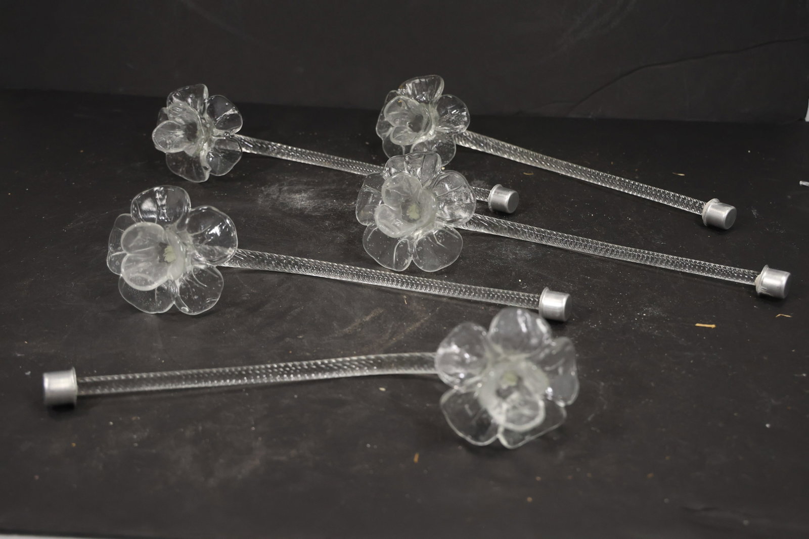 Set of Five Clear Murano Glass Flower Chandelier Stems: Set of Five vintage mid century Murano glass flower chandelier stems from confirmed importer stock. Photographs show curved or straight supports ending in layered blossoms with modeled petals in clear