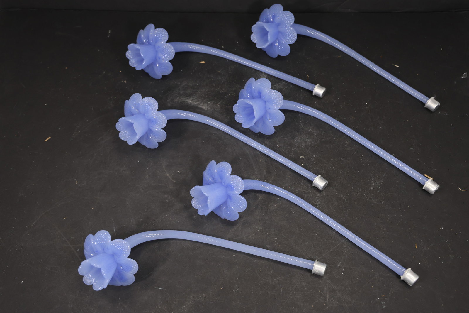 Set of Six Blue Murano Glass Flower Chandelier Stems: Set of Six vintage mid century Murano glass flower chandelier stems from confirmed importer stock. Photographs show curved or straight supports ending in layered blossoms with modeled petals in blue t