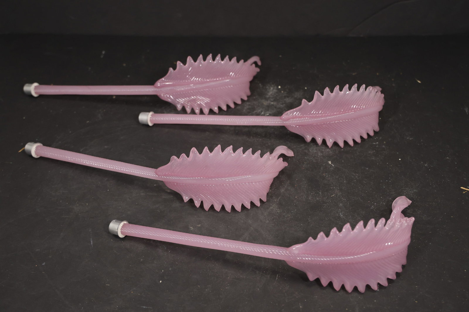 Set of Four Pink Murano Glass Leaf Chandelier Stems: Set of Four vintage mid century Murano glass foliage chandelier stems from confirmed importer stock. Photographs show ribbed leaf bodies with serrated edges and mounting ends in pink tones. Suitable a