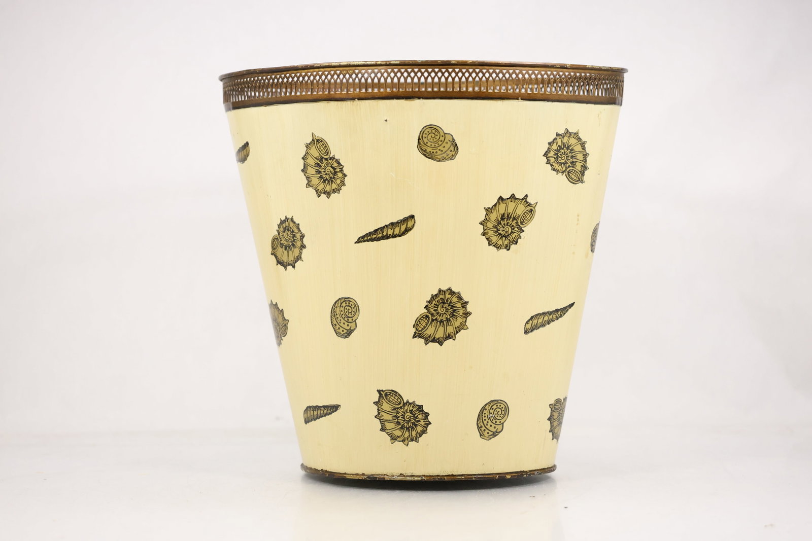 Mid Century Metal Wastebasket with Botanical Motifs: Photographs show mid century metal wastebasket with botanical motifs in cast or worked metal with modeled ornament and a patinated or polished surface. The subject and construction are stated without 