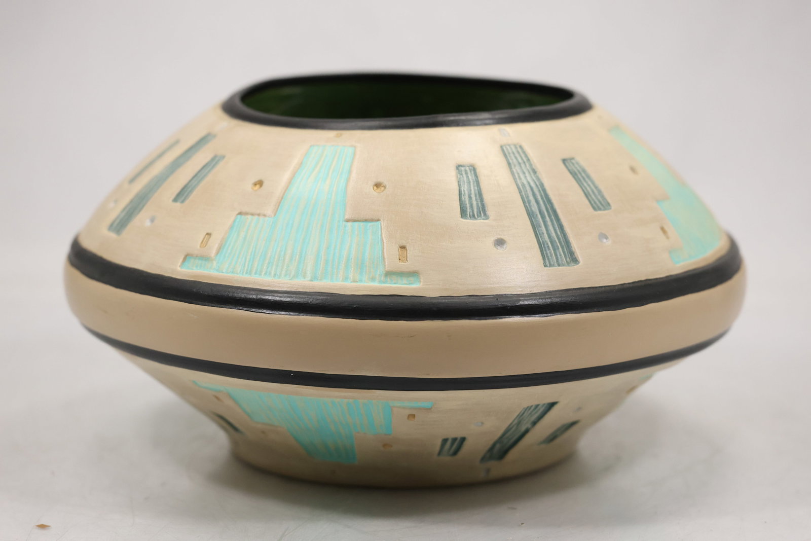 Southwestern Geometric Pottery Bowl Vase: A hand decorated pottery vessel has a rounded bowl form with black red and cream geometric bands. The stepped motifs and earthy palette support a Southwestern style identification while no tribal or i