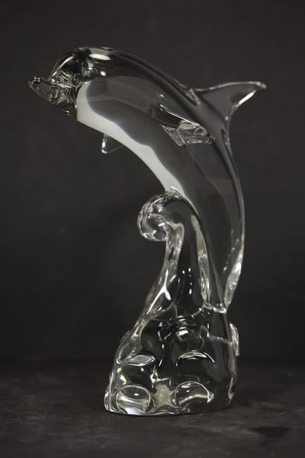 Mid Century Murano Style Glass Dolphin Sculpture: A sculptural dolphin is formed in clear and smoky gray glass with an arched body raised above an integral wave or base. The marine subject hand formed glass construction and mid century Italianate