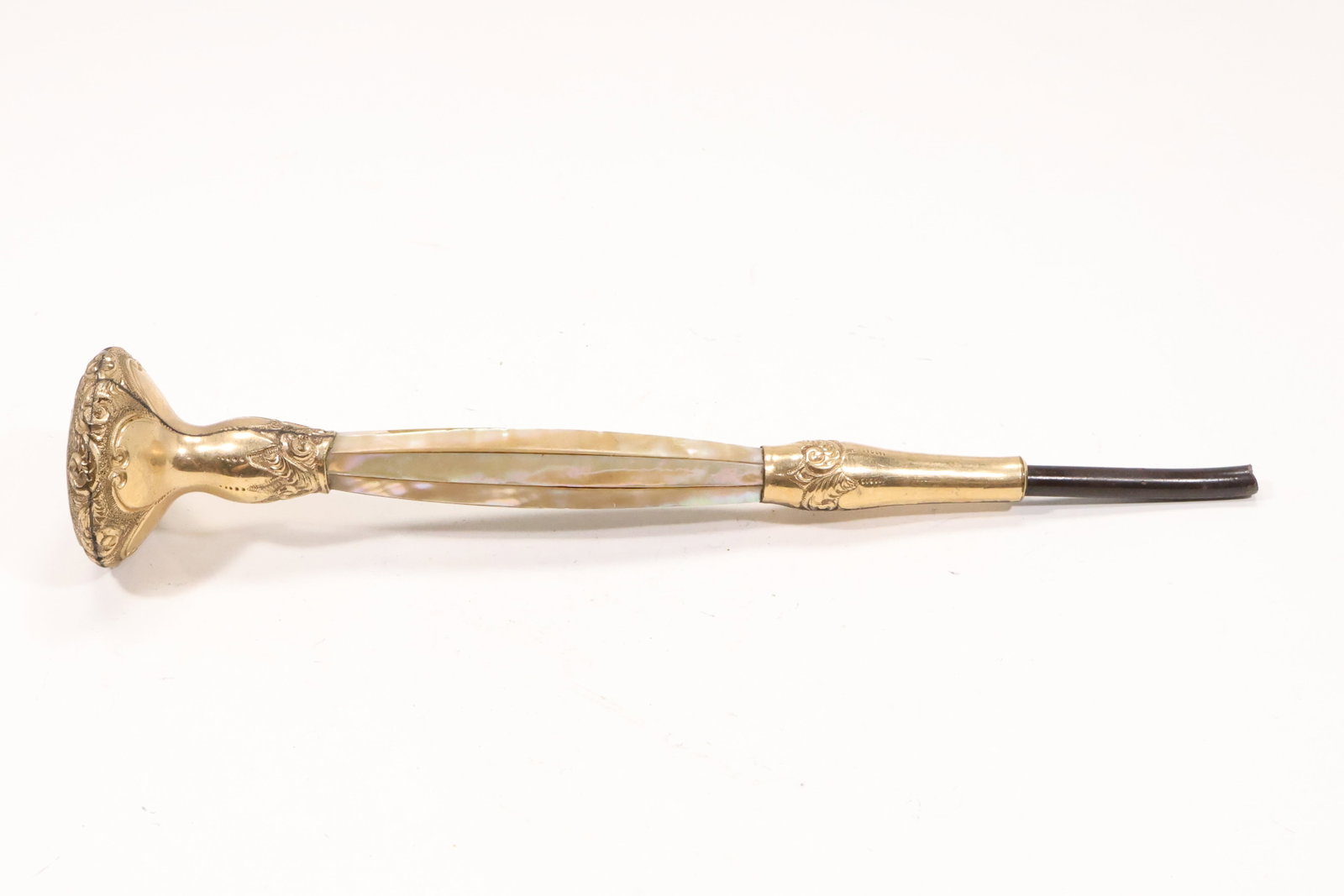 Victorian Gold Filled Mother of Pearl Umbrella Handle: A Victorian umbrella handle has a gold filled decorative mount with inset mother of pearl details and an elongated tapered shaft fitting. The engraved metalwork shell inlay and personal accessory