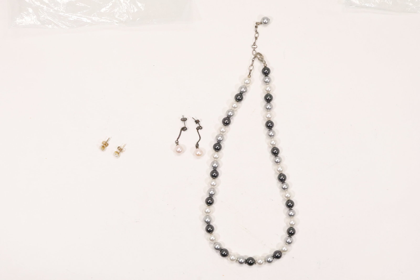Sterling Silver Freshwater Pearl Necklace and Earrings: A coordinated freshwater cultured pearl jewelry set includes a necklace and pierced drop earrings with .925 sterling silver findings. The pearls are arranged in a single strand and matching suspended 