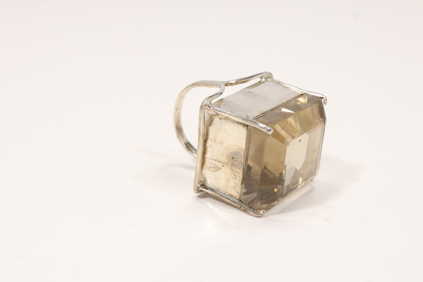 Sterling Silver Ring with Large Citrine Color Stone: A sterling silver statement ring has a large faceted yellow citrine color stone in a raised geometric setting. The bold cocktail ring scale and square cut center are visible in the photographs. The