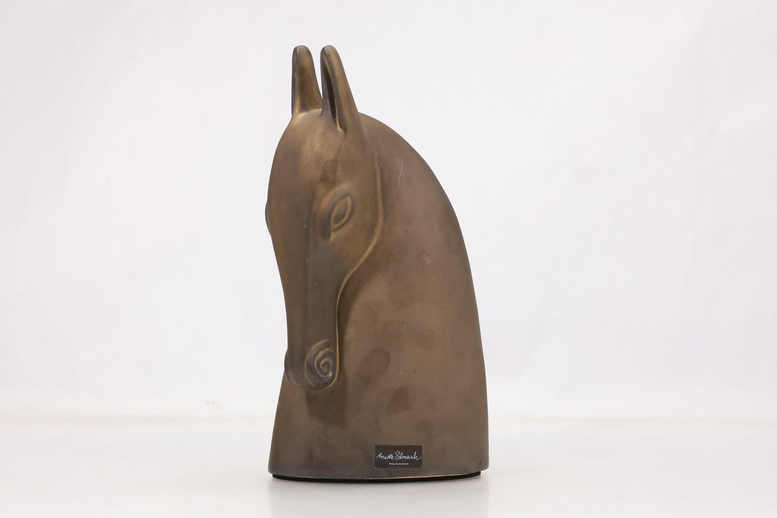 Austin Sculpture Modernist Horse Head: Modernist horse head sculpture with elongated neck simplified mane and a warm brown surface. A base label identifies Austin Sculpture. The work relates to modern decorative sculpture associated with