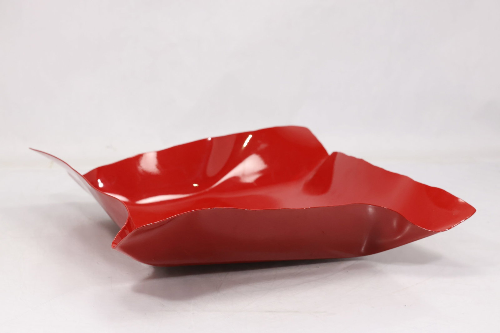 Signed Red Art Glass Centerpiece Tray: Freeform red art glass tray with folded pointed ends and shallow central well. The underside bears an engraved artist signature and 2008 date visible in the photographs. The form relates to twentieth 