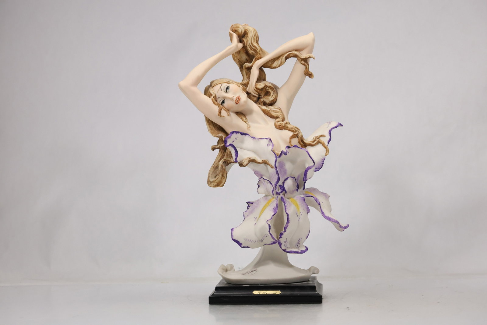 Marked Porcelain Flower Lady Figurine: Decorative porcelain figure of a woman in a flowing dress surrounded by applied flowers and scrolling botanical elements. The underside bears a printed Original mark with a 1988 date. The modeling