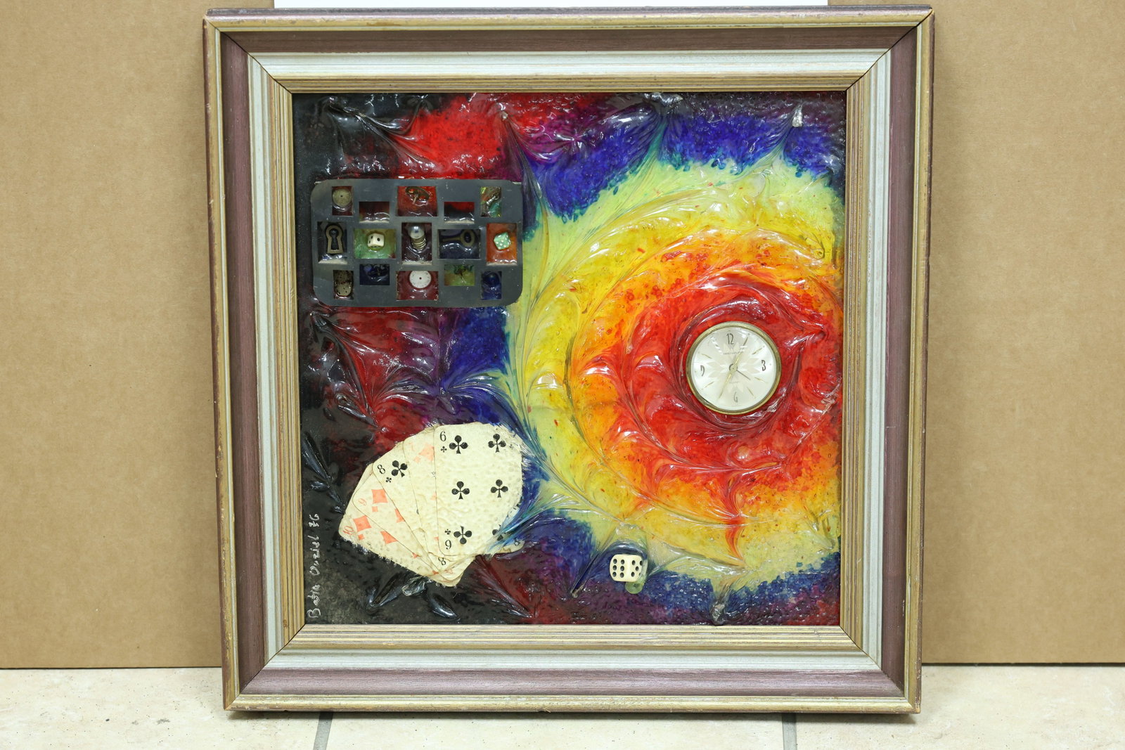 Batia Ouziel 1976 Clock and Playing Card Mixed Media: Framed mixed media assemblage incorporating a clock playing cards a die and electrical grid imagery. The work is signed Batia Ouziel and dated 1976. The combination of found objects and symbolic image