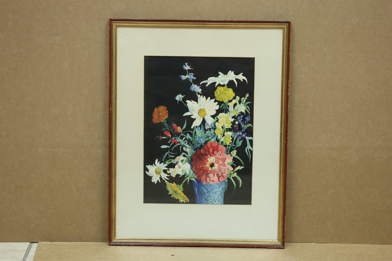 Mary L Fairbanks Floral Watercolor Exhibited 1940: Framed watercolor depicting flowers in a blue vase against a dark ground. A reverse inscription identifies Mary L Fairbanks and notes exhibition at Grace Horne Galleries in Boston during 1940 with a J