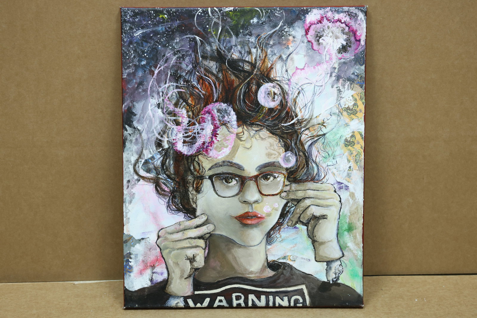 Kayla Golden No 20 Mixed Media Woman Portrait: Framed mixed media portrait of a woman with glasses flowers and printed WARNING text. The reverse is marked Kayla Golden 6 and No 20. The flattened figure and saturated color relate to Pop Art and Neo