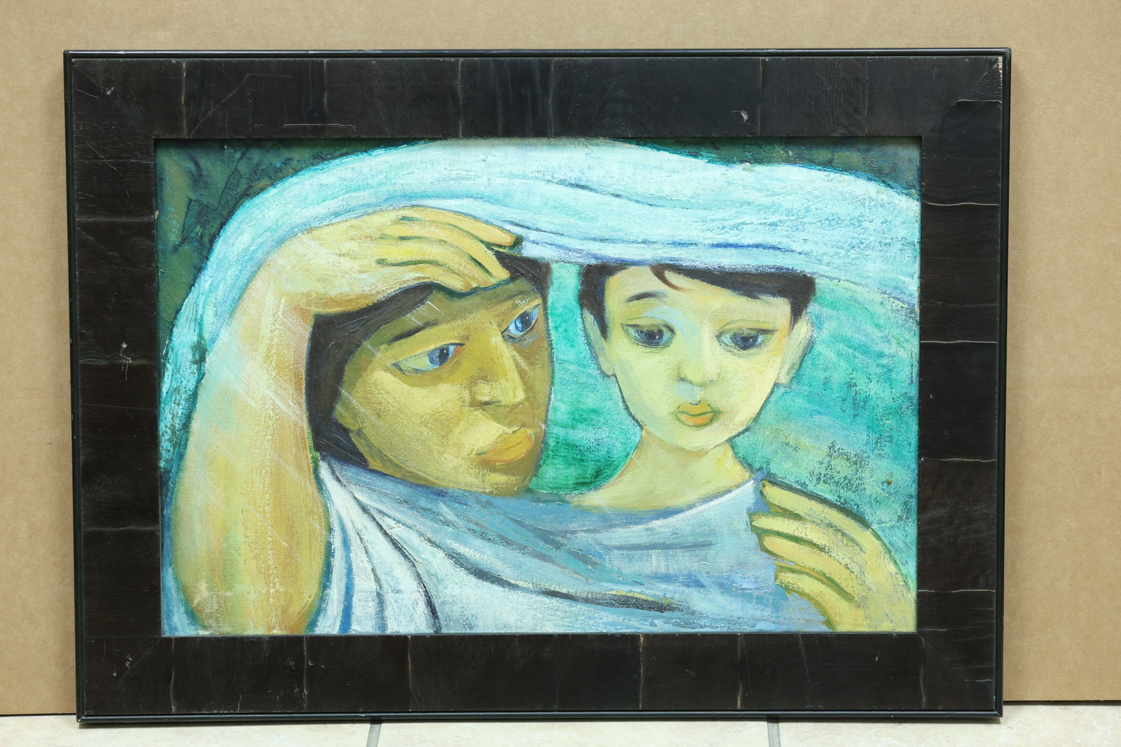 Miguel Annival Mother and Child Figural Painting: Framed painting depicting a mother holding a child in a simplified modern style. A pasted Spanish language biography on the reverse identifies painter Miguel Annival. The simplified figure and express