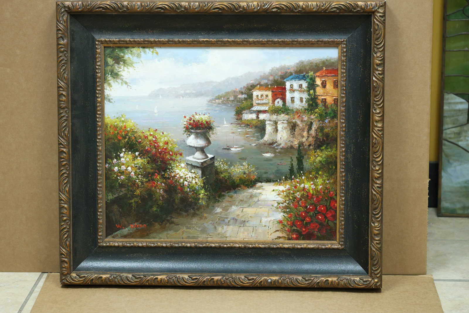 W Dixon Signed Italian Coastal Village Painting: Framed landscape painting depicting an Italian coastal or lakeside village with boats and flowers in the foreground. The work is signed W Dixon. The broken color and atmospheric handling relate to Imp