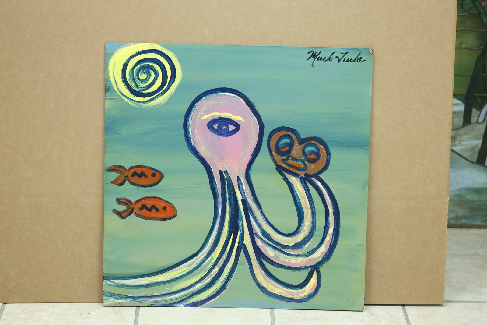 Mark Tuela Style One Eyed Octopus Folk Painting: Framed folk painting depicting a one eyed octopus holding a pretzel with two fish against a colorful ground. The signature appears to read Mark Tuela but the spelling is not fully confirmed. The direc