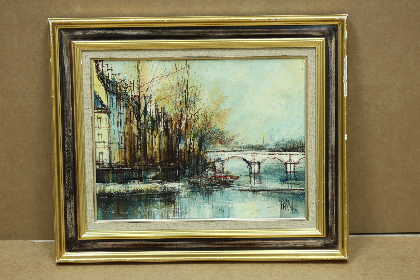 Frank Signed Paris River Bridge and Street Painting 1962: Framed Paris view depicting a river bridge buildings and street activity. The work is signed FRANK and dated 62. The broken color and atmospheric handling relate to Impressionist landscape traditions 