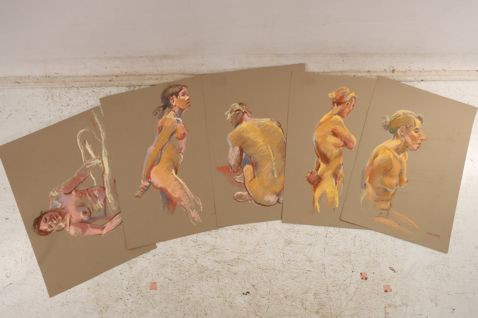 Group of Five Seated Back and Standing Nude Pastel Studies by Unidentified Artist: Group of five pastel figure studies on paper by an unidentified artist depicting seated back view standing and turning female nude models with warm yellow and red color. Each work is dated and unsigne