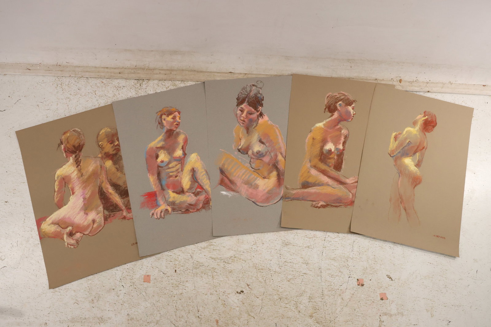 Group of Five Seated Profile and Back View Nude Pastel Studies by Unidentified Artist: Group of five pastel figure studies on paper by an unidentified artist depicting seated profile back view and upright female nude models in warm red yellow and gray. Each work is dated and unsigned. N
