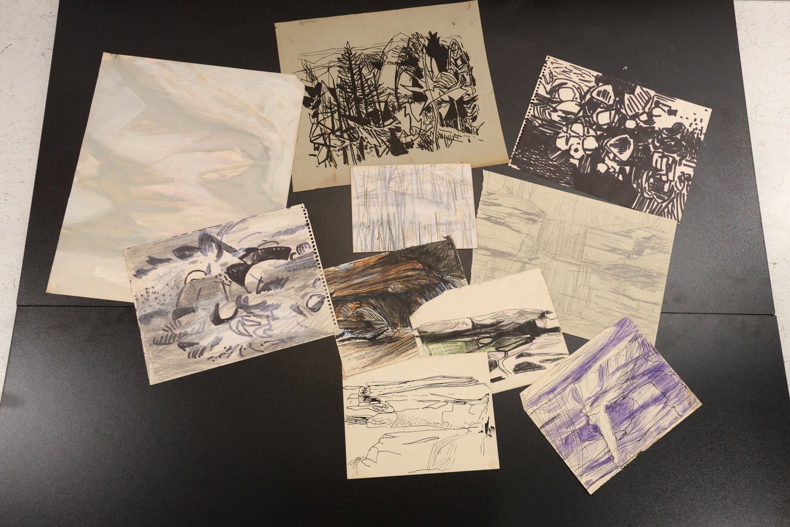 Robert Angeloch Assorted Woodstock Landscape Study Drawings: Group of original landscape study drawings on paper by Robert Angeloch with wooded terrain fields and abstracted natural forms. The drawings use black brown blue violet and graphite like marks. The bo