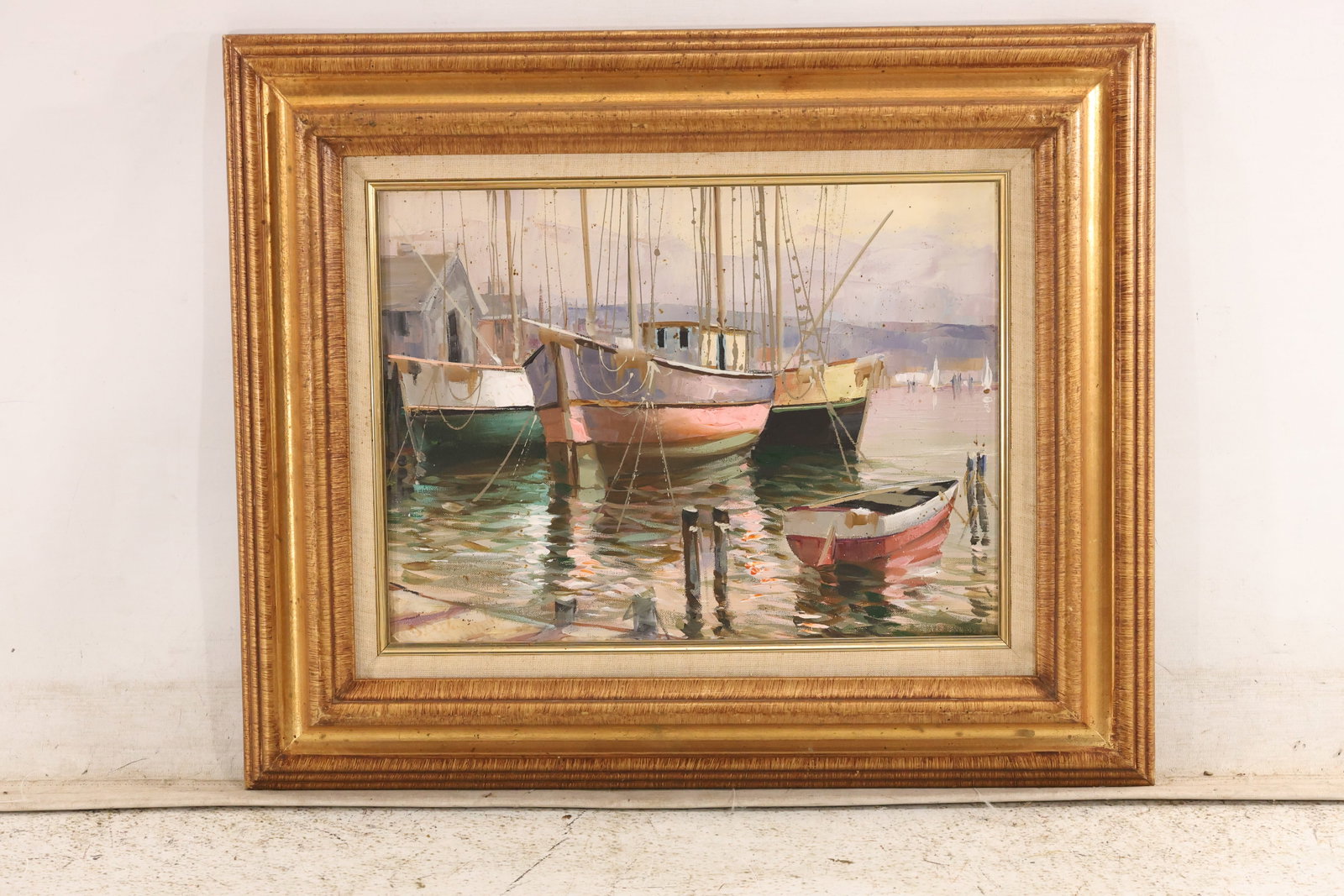 Nidia DAlessandro Harbor Boats Painting with Artist Label: Framed harbor painting associated with Nidia DAlessandro depicting moored boats rigging and reflected color on calm water. The photographed back includes an artist information label and an inventory n