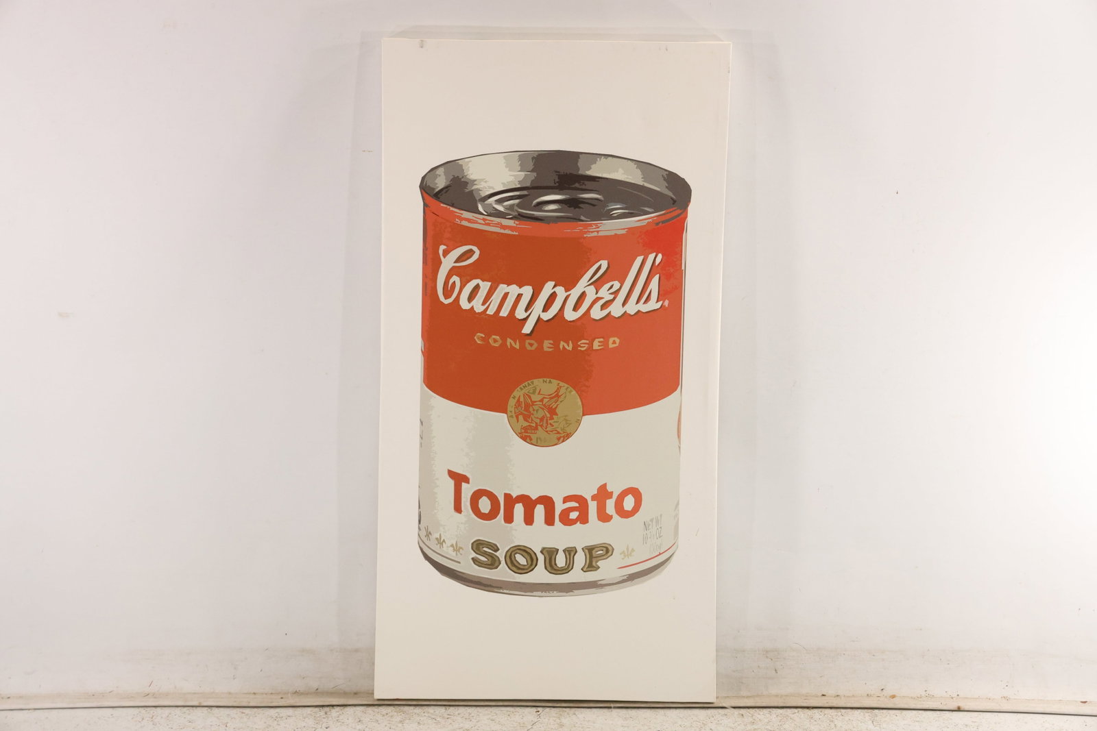Campbell Tomato Soup Pop Art Print on Canvas: Graphic print on canvas depicting a Campbell tomato soup can on a plain light ground. The elongated vertical format emphasizes the familiar red white and metallic package design. The subject directly