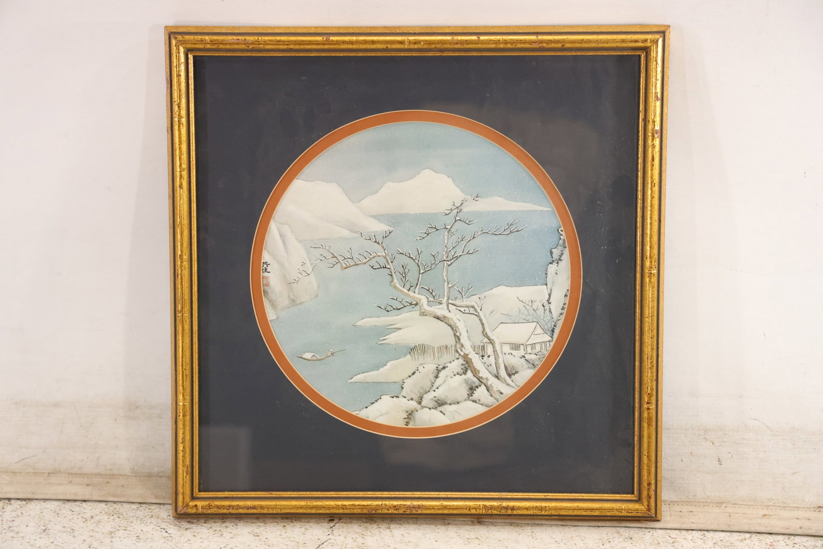 Modern Japanese Winter Landscape Woodblock Style Print: Modern decorative print in the style of a Japanese woodblock depicting a snow covered tree and distant mountains within a circular image field. The reverse shows a patterned backing panel and no