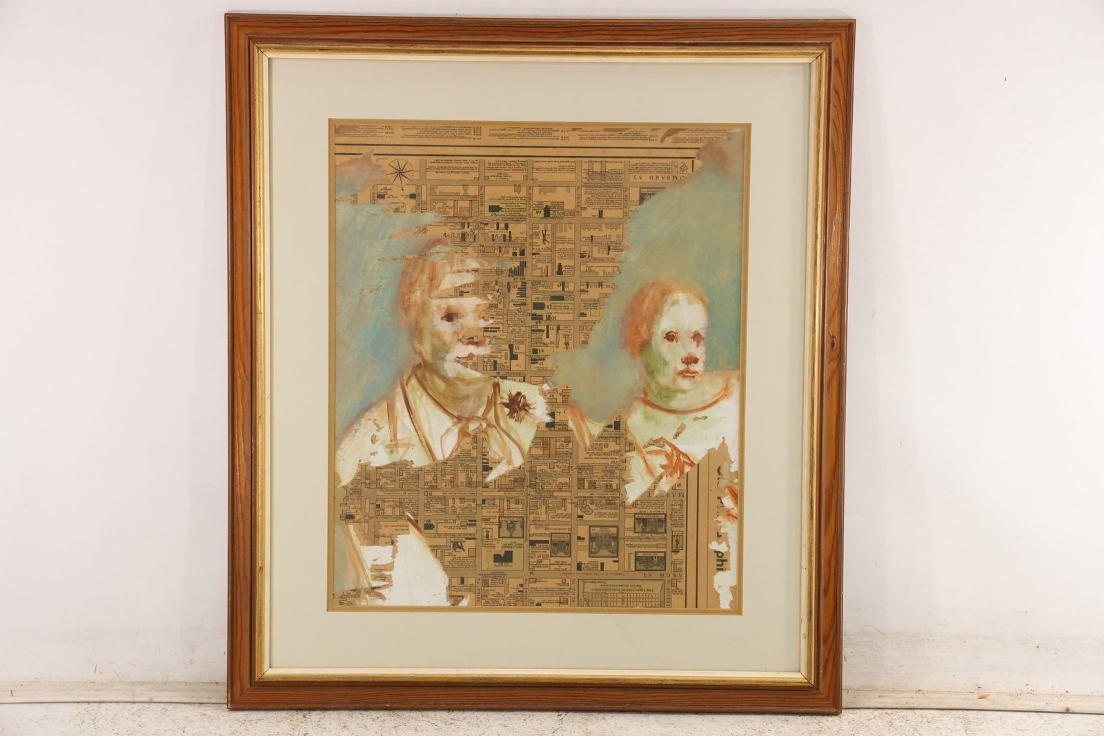 Unsigned Mixed Media Portrait Collage: Unsigned framed mixed media composition combining two pale portrait heads with layered maps printed text and architectural fragments. The work is presented under glass with a wide mat and decorative f