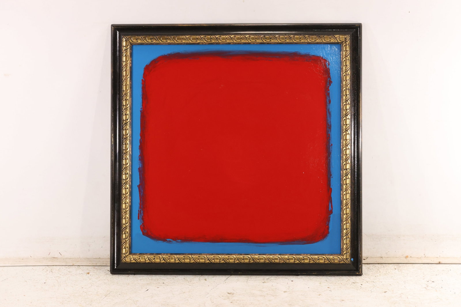 Signed Tom Pulgini Red and Blue Color Field Oil Painting: Signed Tom Pulgini oil painting on board depicting a minimal red rectangular field surrounded by a narrow blue border and presented in a dark decorative frame. The work uses simplified forms strong bl