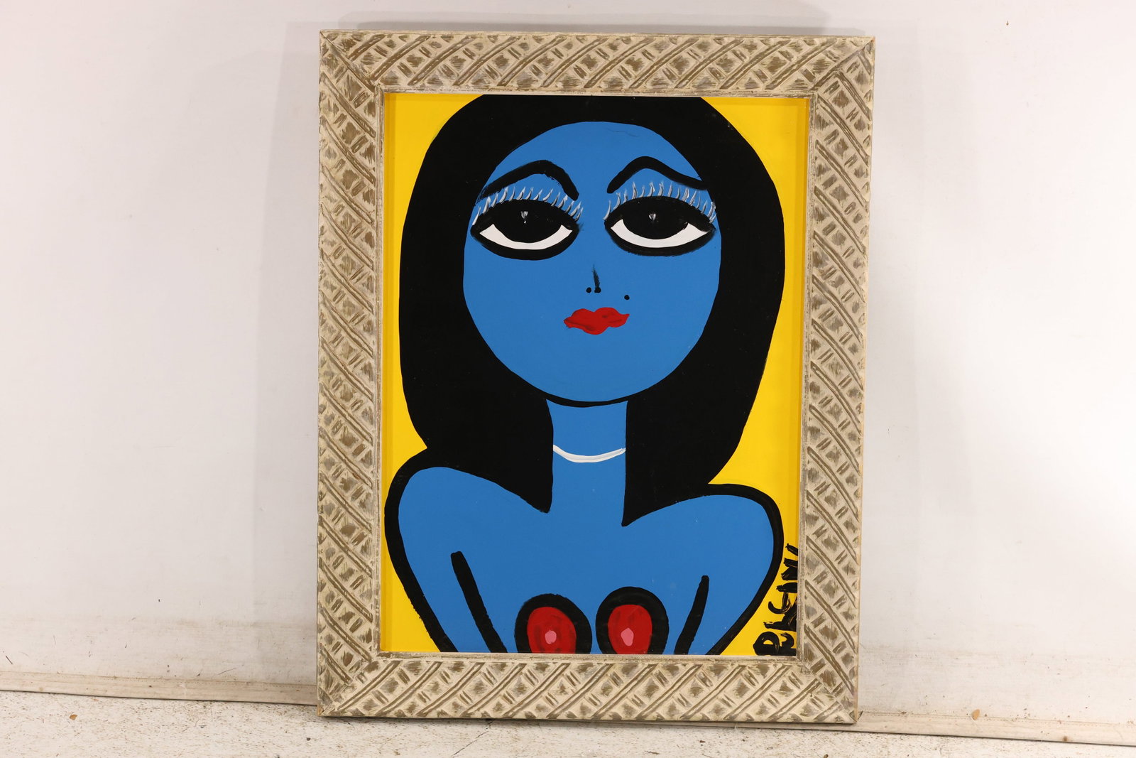 Signed Tom Pulgini Blue Female Bust Oil Painting: Signed Tom Pulgini oil painting on board depicting a blue female bust with black hair and large dark eyes framed by a yellow field and patterned silver tone frame. The work uses simplified forms stron