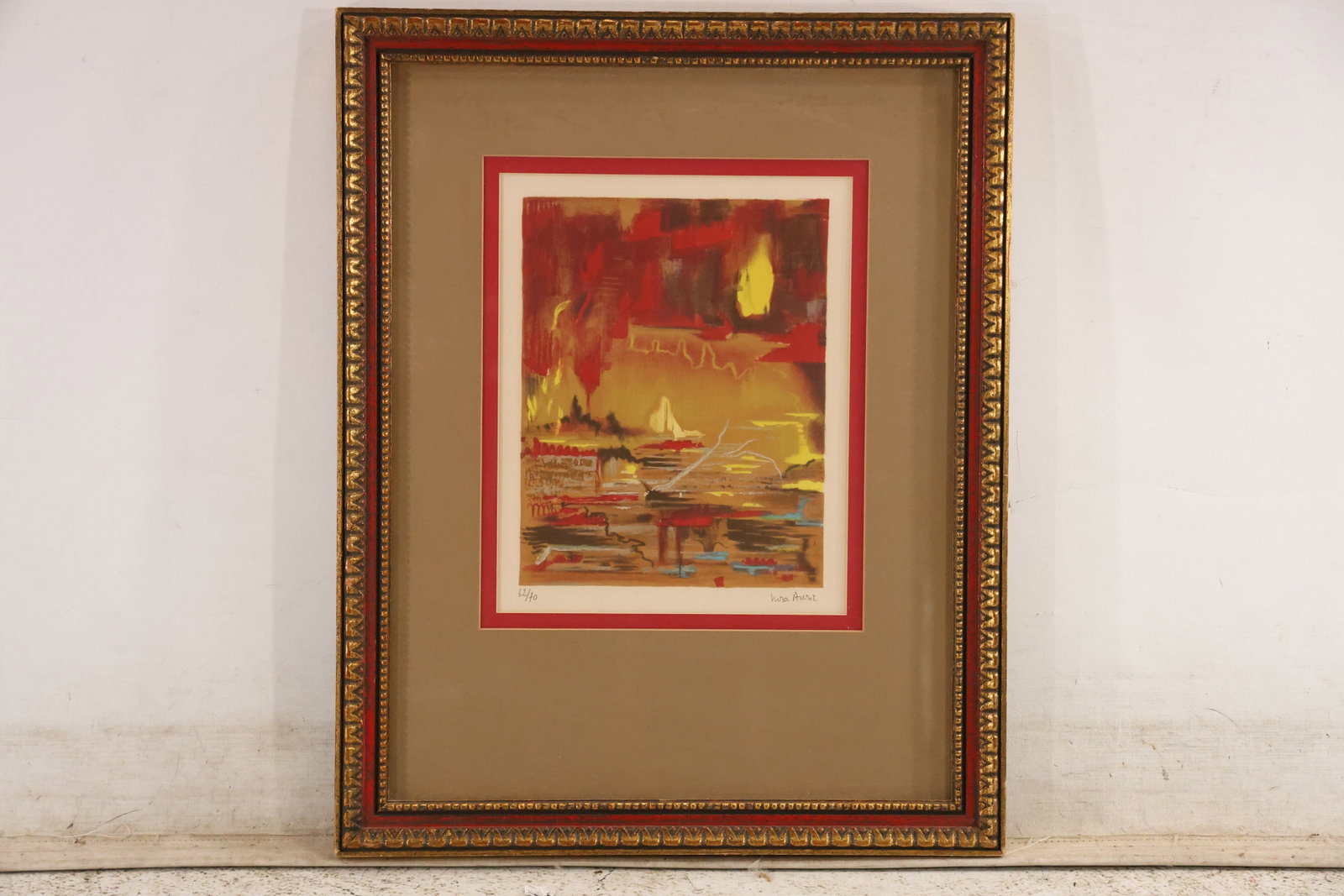 Signed Nora Auric Abstract Color Lithograph 62 of 70: Limited edition color abstract lithograph signed Nora Auric in pencil at the lower right and numbered 62 of 70 at the lower left. Layered red orange yellow and dark passages create a compact atmospher
