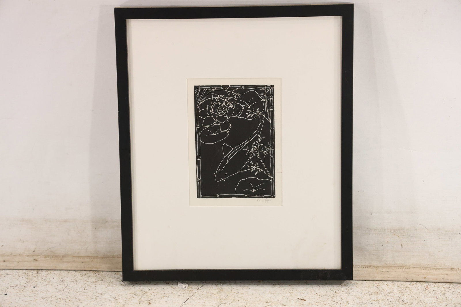 Signed Koi and Lotus Black and White Relief Print: Signed black and white relief print depicting a koi swimming beneath a lotus blossom within a border of stylized bamboo and water plants. The artist signature appears in pencil at the lower right marg