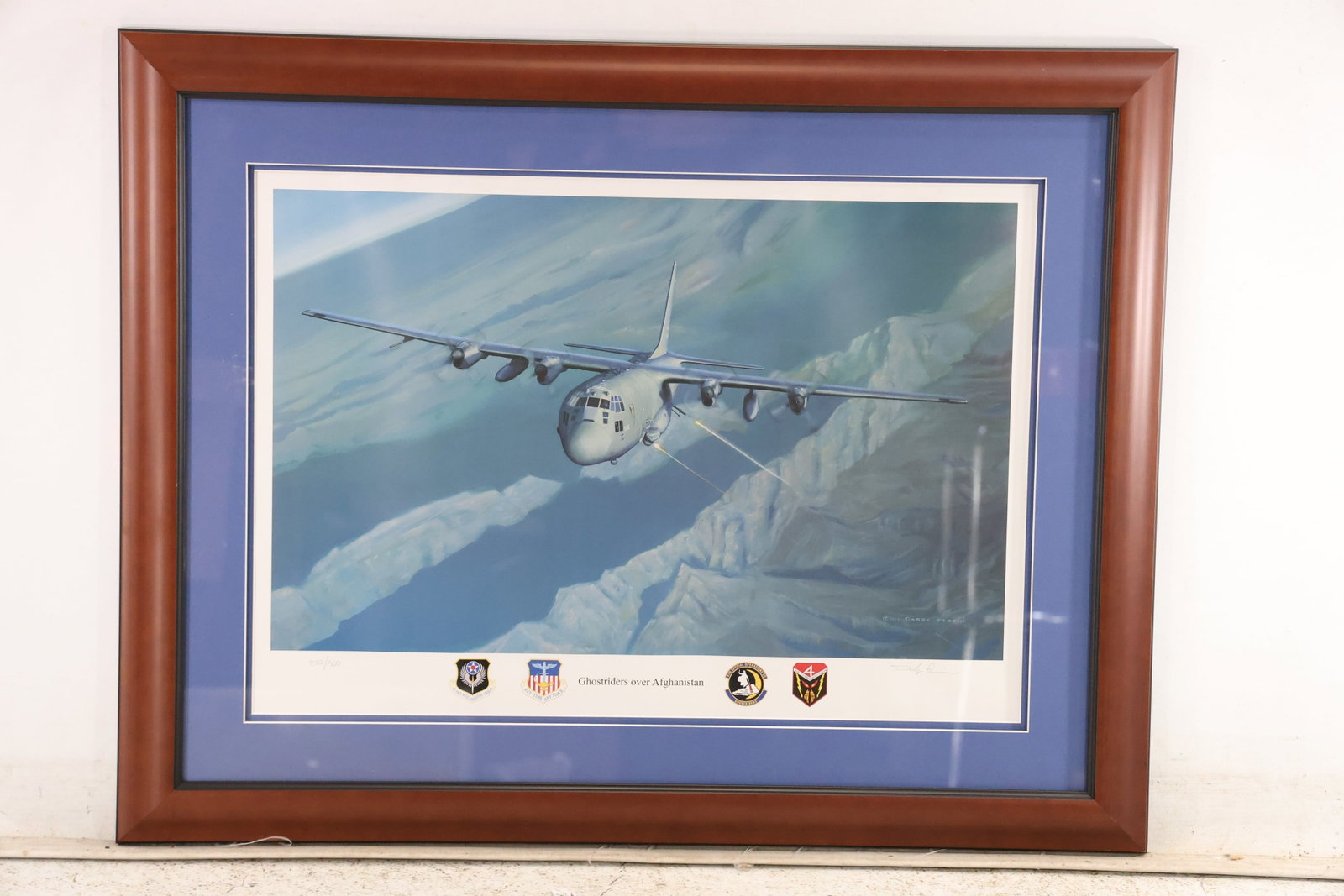 Darby Perrin Ghostriders over Afghanistan Print 220 of 500: Signed limited edition military aviation print titled Ghostriders over Afghanistan by Darby Perrin. An AC 130U Spooky gunship flies above the rugged mountains of Afghanistan while dispensing defensive