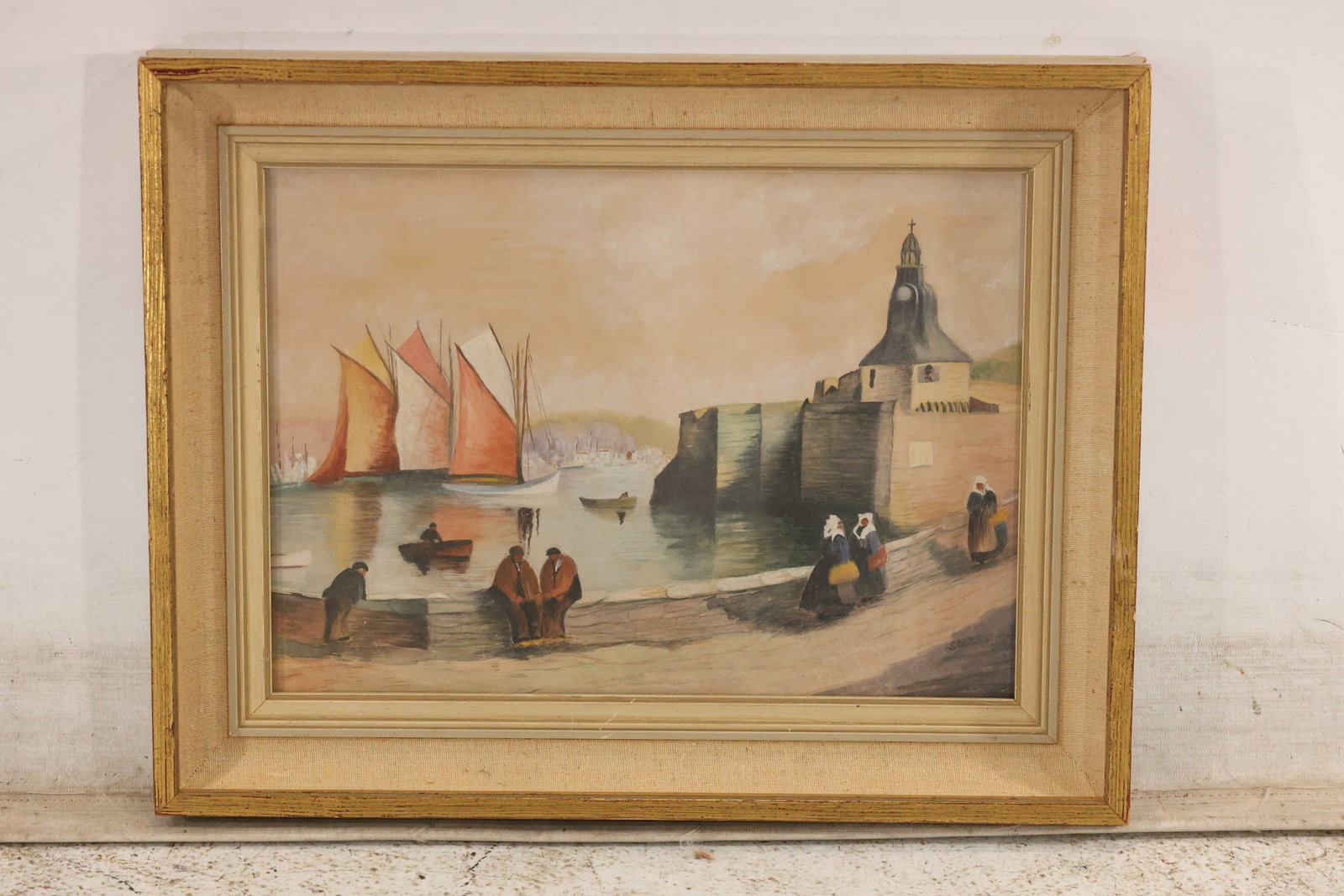 Signed Harbor Scene Watercolor and Gouache: Painting on paper depicting fishing boats with rust-orange sails, stone harbor walls, a lighthouse or tower, and figures. Signed lower right. Presented in a decorative gold-toned frame with a fabric