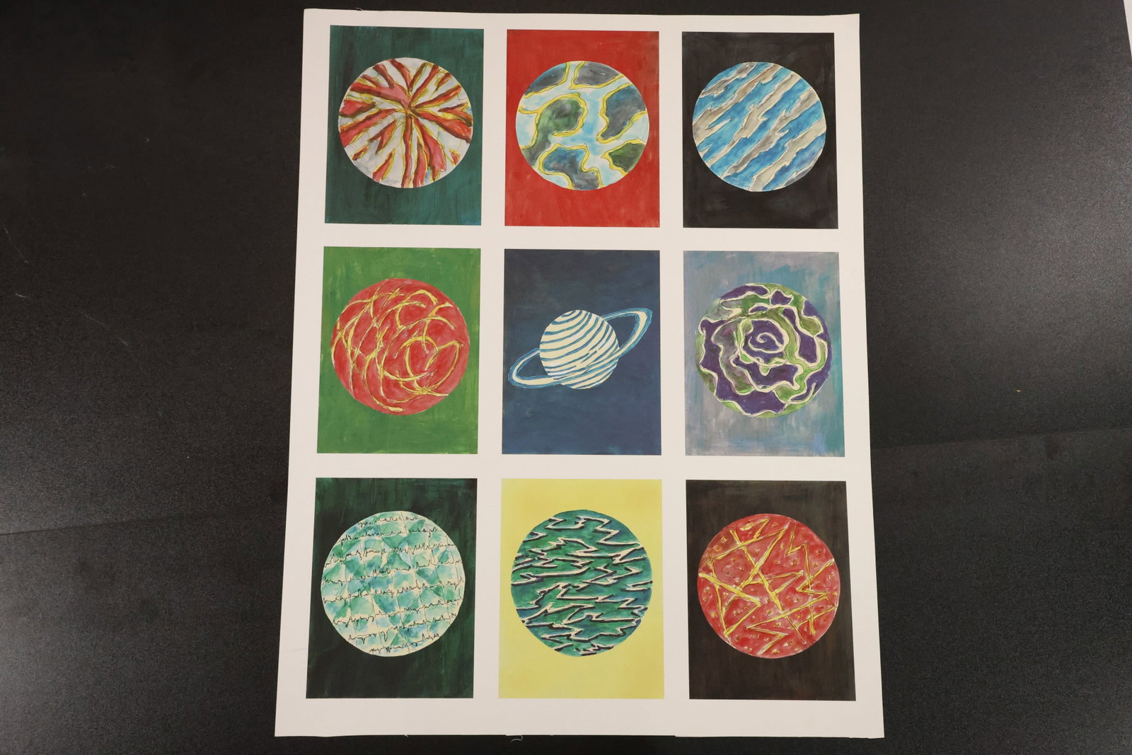 Nine Planet and Space Studies Painting on Paper: Hand-painted composition on paper arranged as a grid of nine colorful space studies, including striped planets, a ringed planet, and swirling celestial forms. Size: 28 x 22 inches. Shelf ID: mc1 **Pic