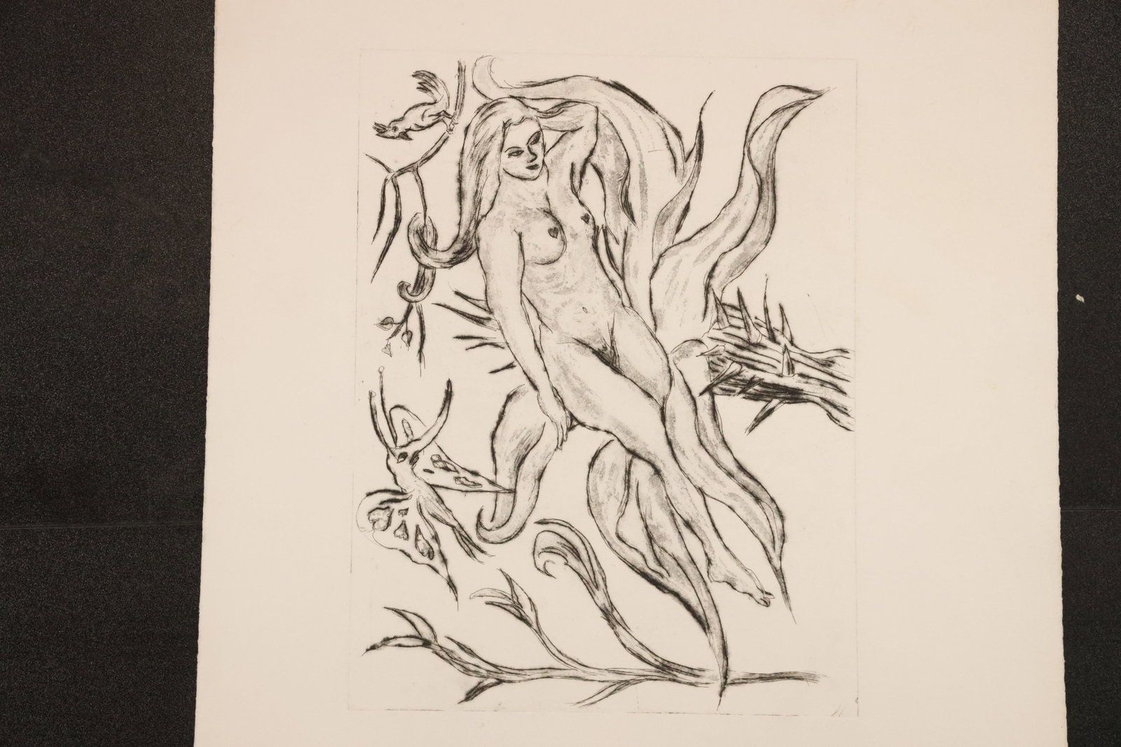 Female Nude among Foliage Woodblock Print: Black-and-white woodblock print on paper depicting a female nude intertwined with flowing leaves and branches. Size: Paper: 22 x 15 inches. Shelf ID: mc1 **Pickup Notice:** This item requires a confir