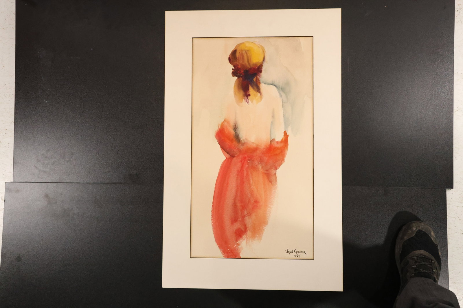 Signed Watercolor of Woman in a Red Dress: Watercolor on paper depicting a woman from behind with a yellow-brown head covering and a loosely draped red dress. Signed and dated at lower right. Size: 30 x 19 inches. Shelf ID: mc3 **Pickup Notice