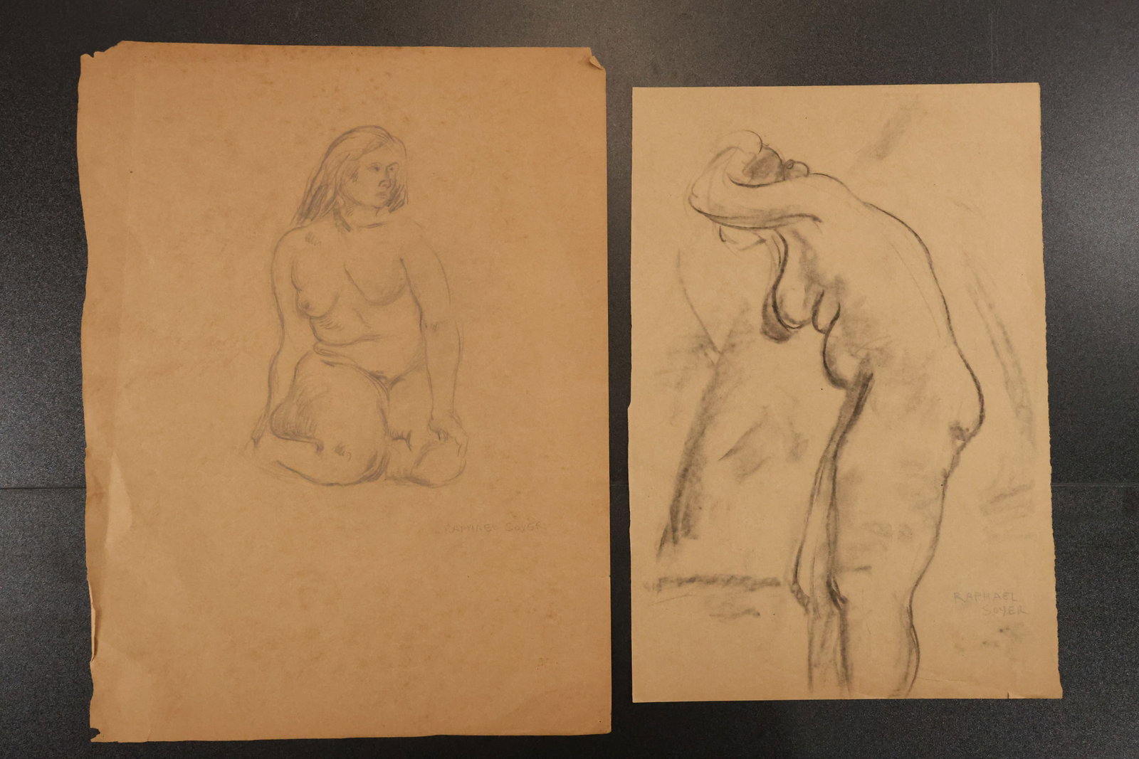 Raphael Soyer Two Original Female Figure Drawings: Two original figure drawings on paper depicting a seated nude and a standing woman. One sheet bears the name Raphael Soyer and the other a signature. From a portfolio according to the consignor’s no
